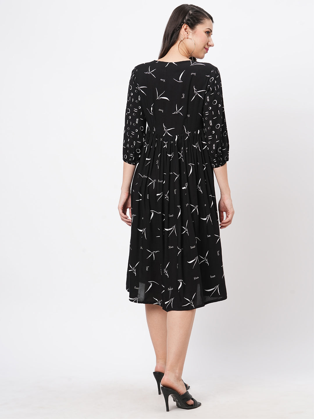 Featuring A Wide Black Dress With Gathers And Sleeves In Complimenting Print