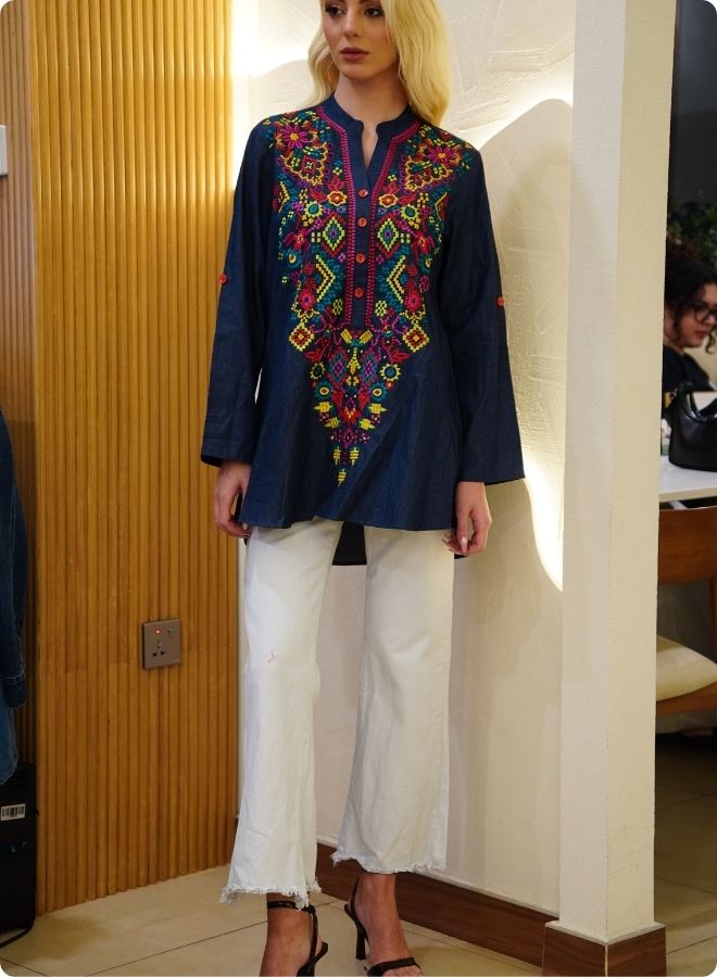 Featuring denim blue tunic with multi coloured thread embrodery