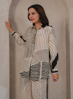 a beige and black striped coord set with a collared top and wide-leg pants