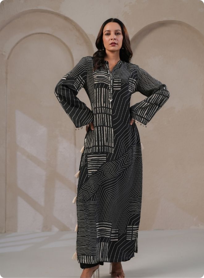 a long black and white geometric patterned coord set with side tassels