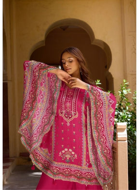 Vibrant Fuchsia Ethnic Wear Against Traditional Indian Architecture