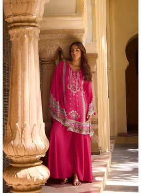 Vibrant Fuchsia Ethnic Wear Against Traditional Indian Architecture