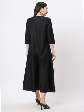 Featuring A Black Silk Blend Below Calf Jumpsuit With Multi Color Trim At The Neck And Sleeve Hem