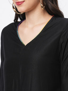 Featuring A Black Silk Blend Below Calf Jumpsuit With Multi Color Trim At The Neck And Sleeve Hem