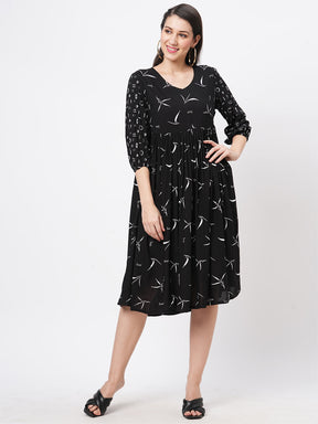 Featuring A Wide Black Dress With Gathers And Sleeves In Complimenting Print